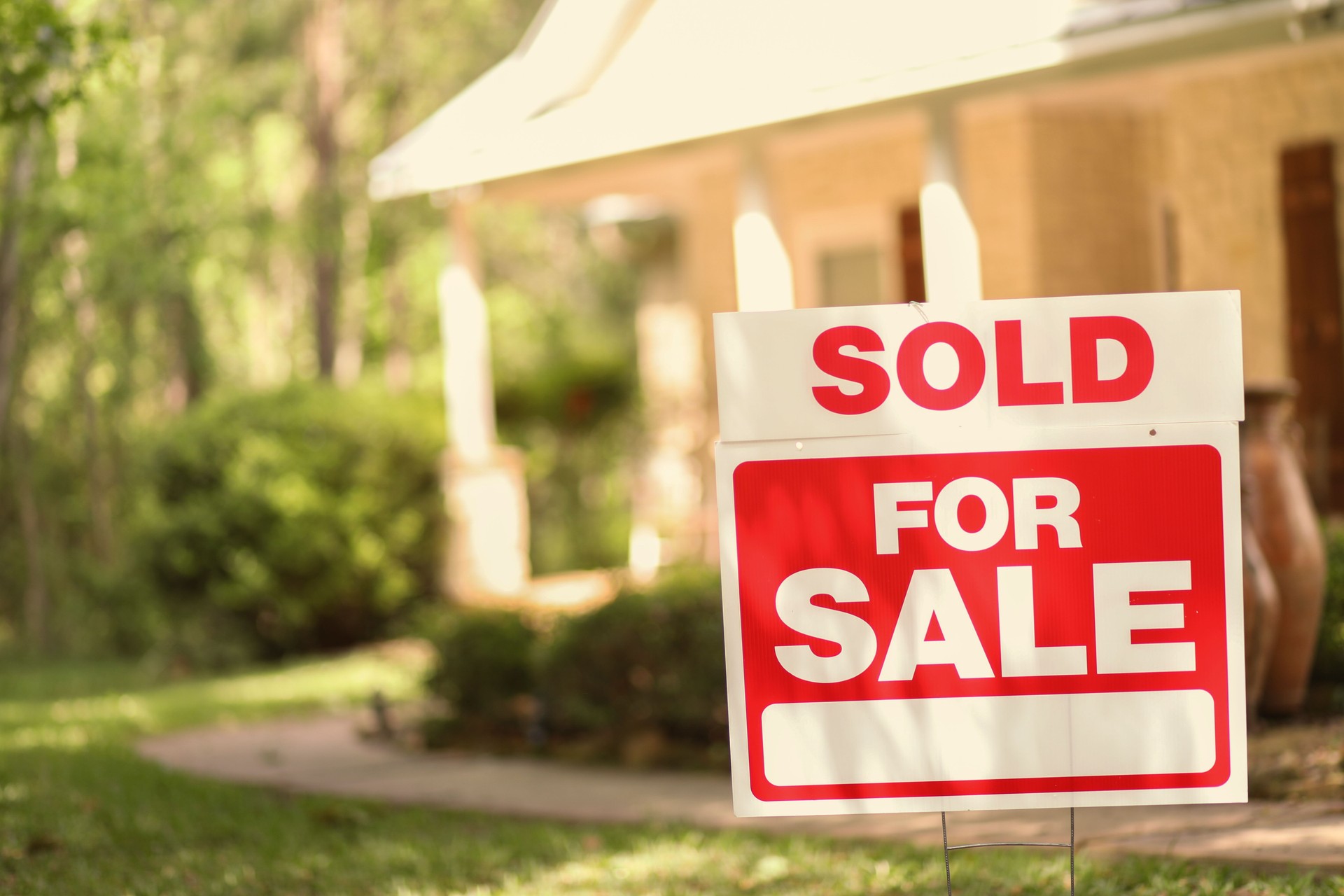 Home for sale with real estate sign.